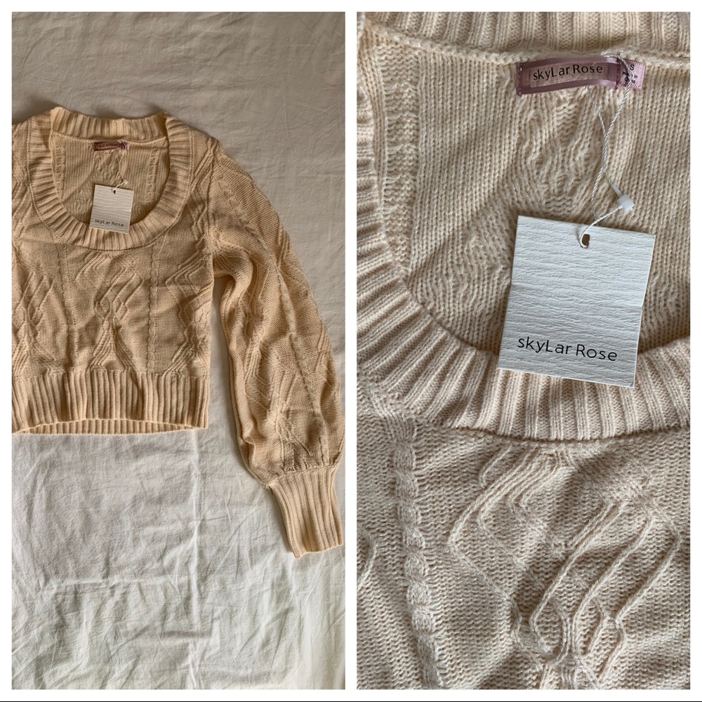 Cropped long sleeve sweater. Tan/pink hue color.